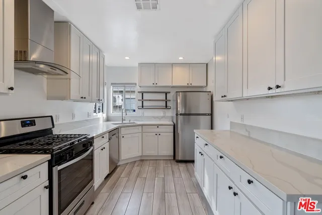 a kitchen with granite countertop a stove and a sink