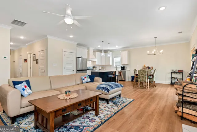a living room with furniture and kitchen view