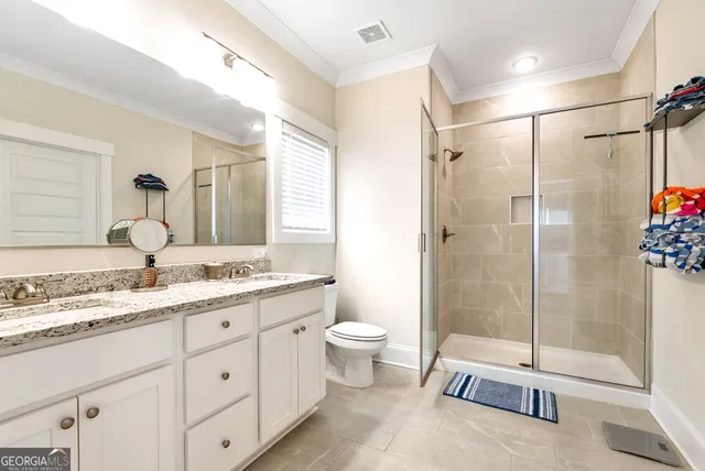 a spacious bathroom with a granite countertop sink mirror and toilet