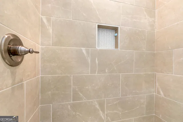 a bathroom with a shower and a window