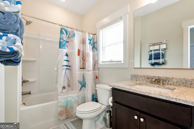 a bathroom with a sink a toilet and a bathtub