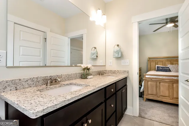 a bathroom with a granite countertop sink and a mirror