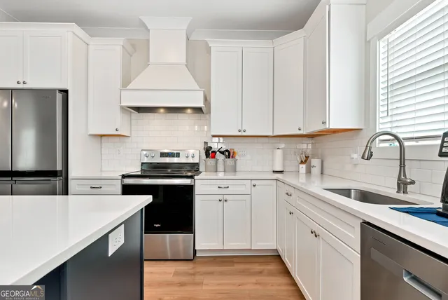 a kitchen with a sink stove and refrigerator