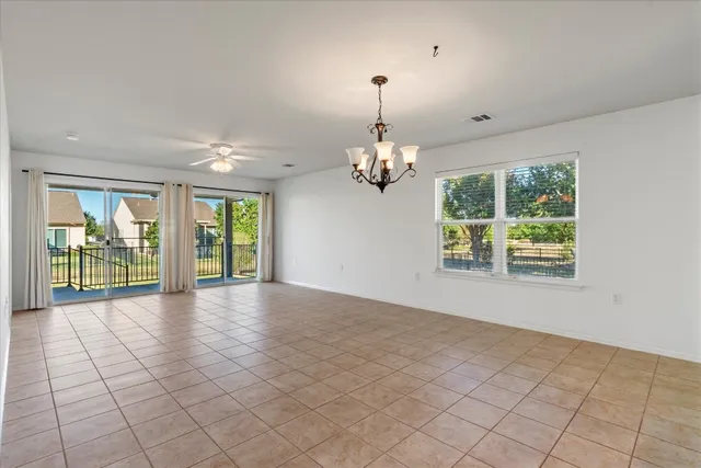 a view of a livingroom with furniture and chandelier fan