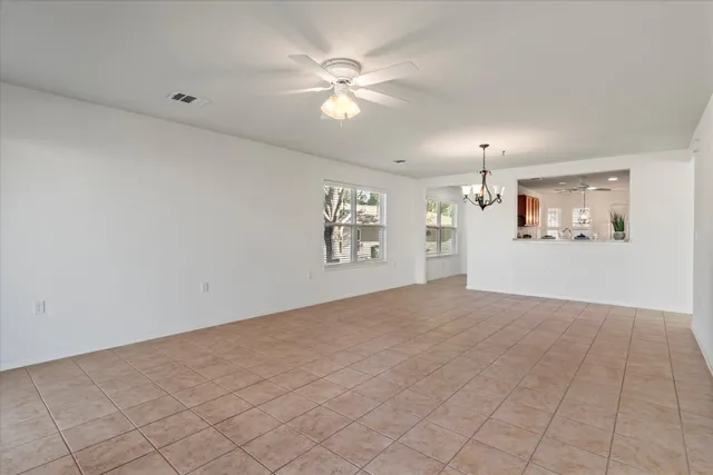 a view of a livingroom with a ceiling fan and window