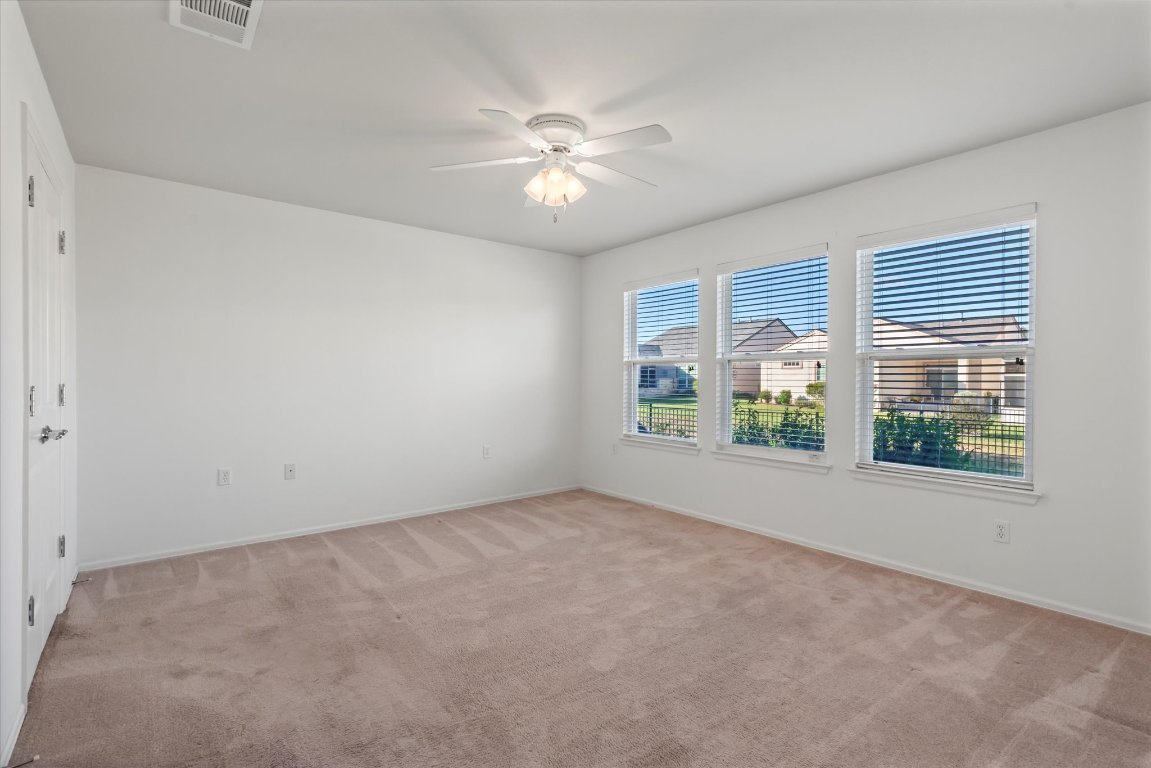 325 Barrington Farm Court Georgetown, TX 78633 - Photo 20 of 40 an empty room with windows and chandelier fan