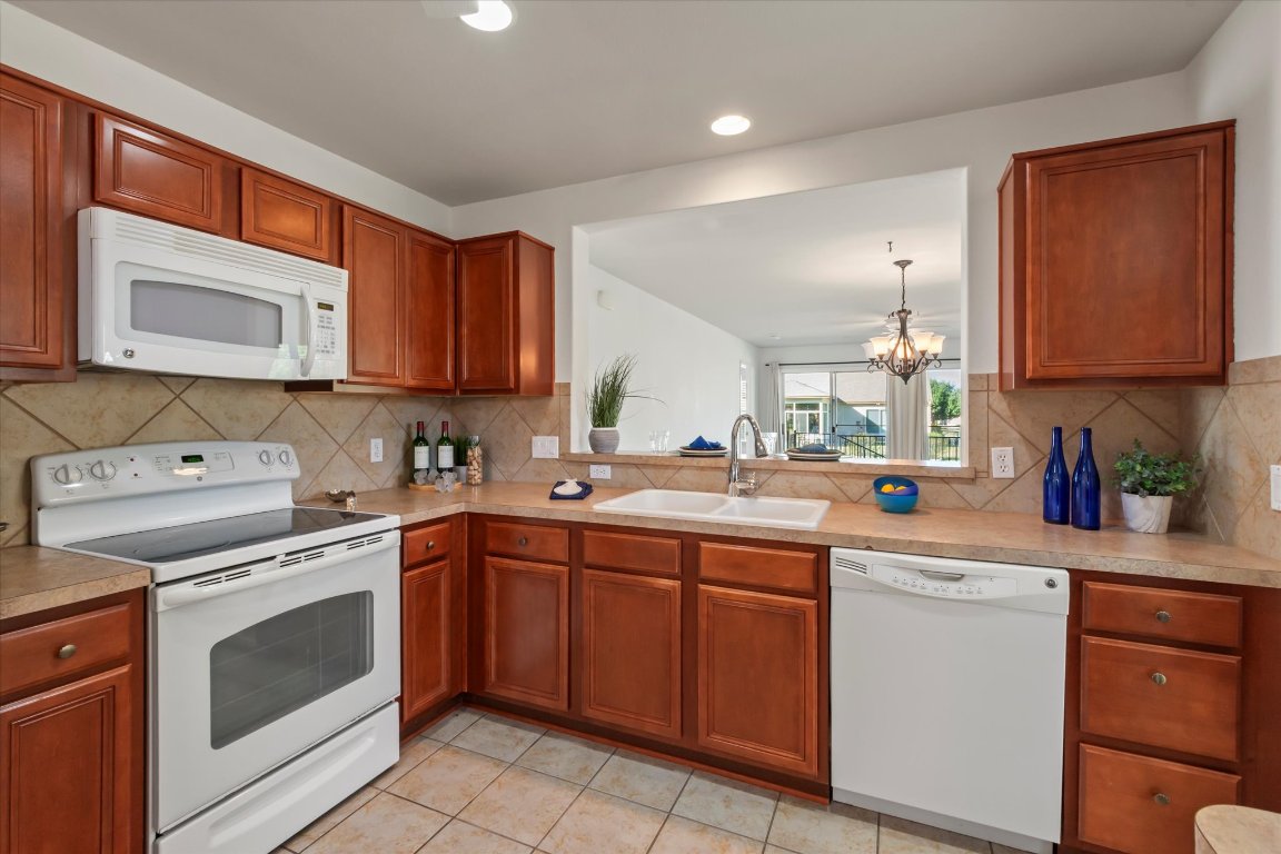 325 Barrington Farm Court Georgetown, TX 78633 - Photo 6 of 40 a kitchen with a sink stove top oven and cabinets