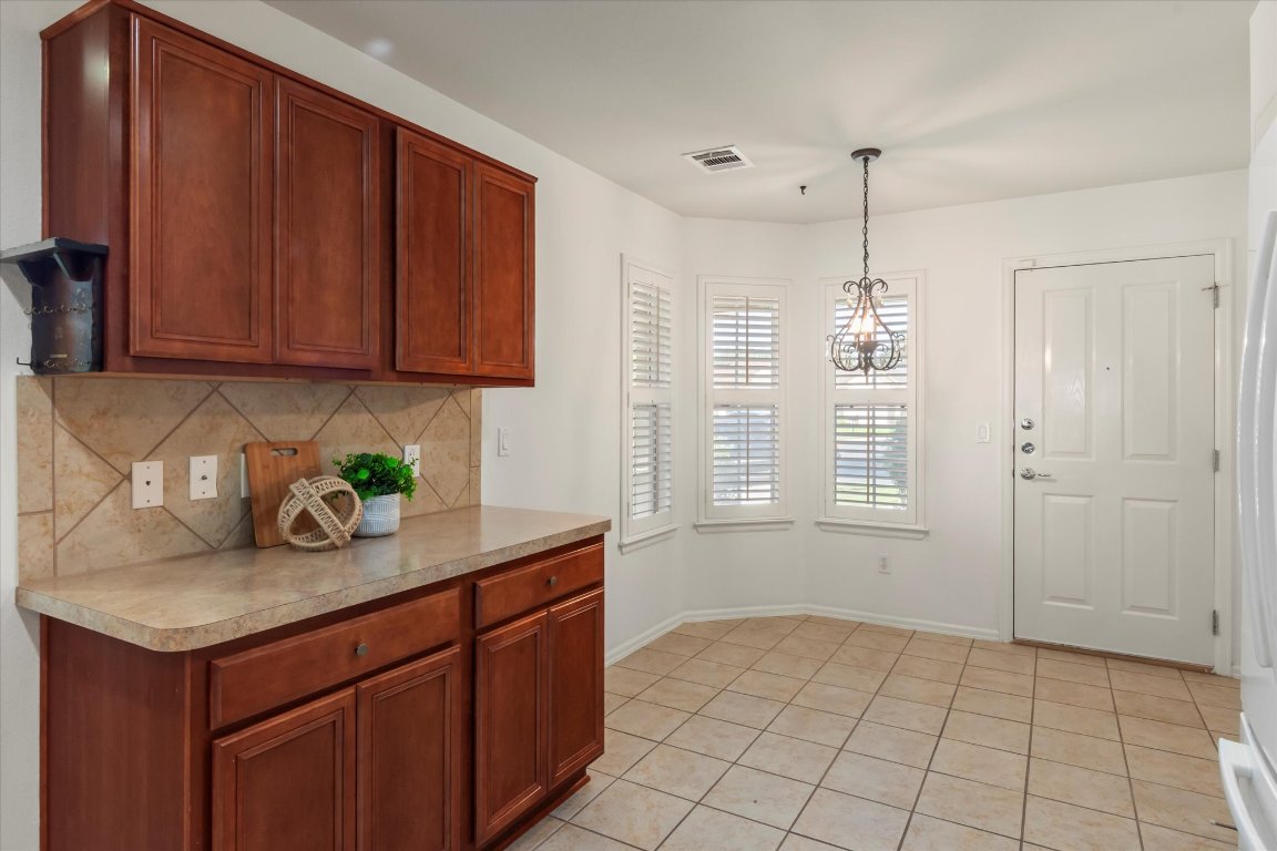 325 Barrington Farm Court Georgetown, TX 78633 - Photo 7 of 40 a kitchen with stainless steel appliances granite countertop a sink and a white cabinets