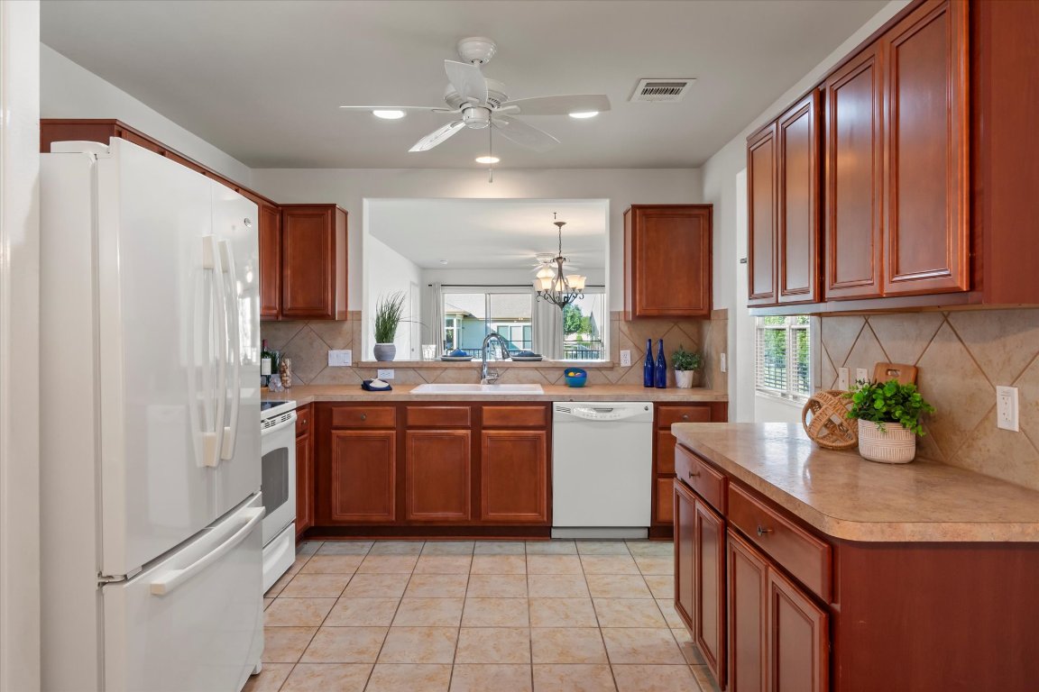 325 Barrington Farm Court Georgetown, TX 78633 - Photo 8 of 40 a kitchen with kitchen island granite countertop a sink counter top space appliances and cabinets