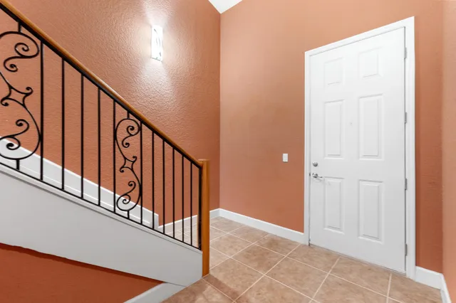 a view of staircase with lots of frames on wall