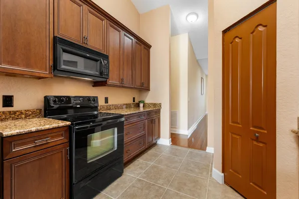 a kitchen with stainless steel appliances granite countertop a stove and a microwave