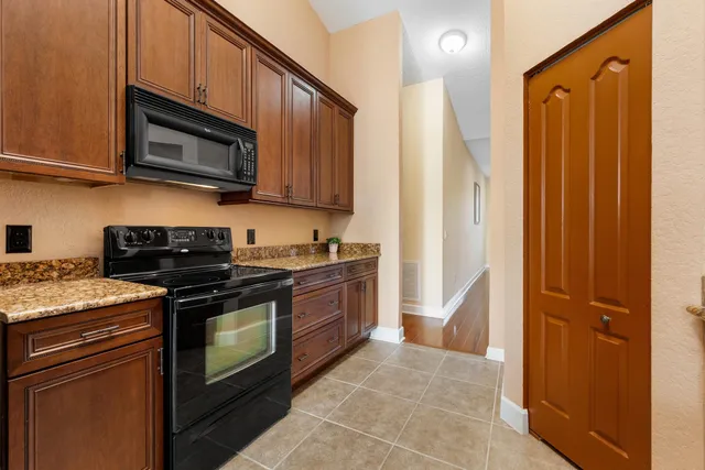 a kitchen with stainless steel appliances granite countertop a stove and a microwave