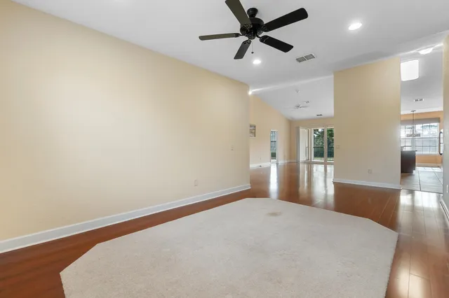 a view of a livingroom with a ceiling fan and wooden floor