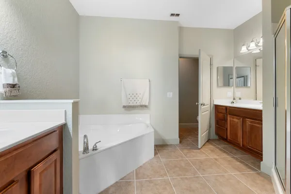 a bathroom with a tub sink and a mirror