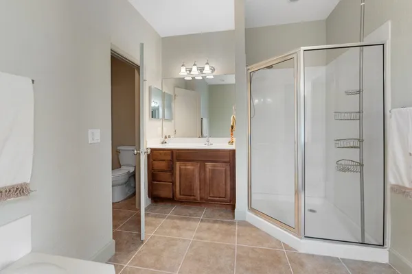 a bathroom with a shower a sink and a mirror