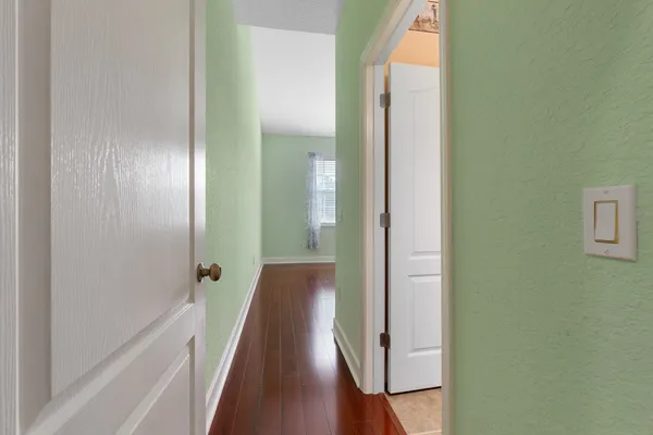 a view of a hallway with wooden floor