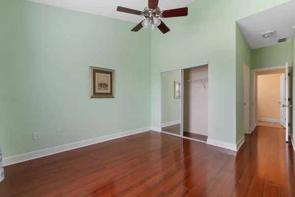 a view of empty room with wooden floor
