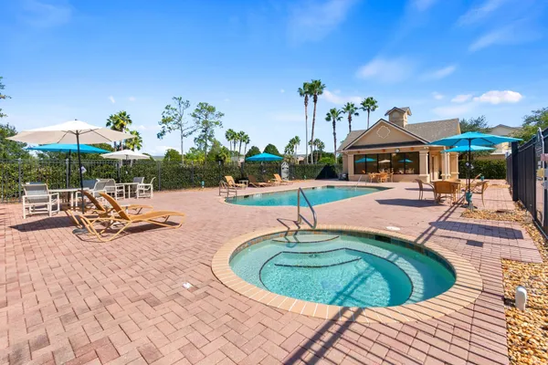 a swimming pool with outdoor seating and yard