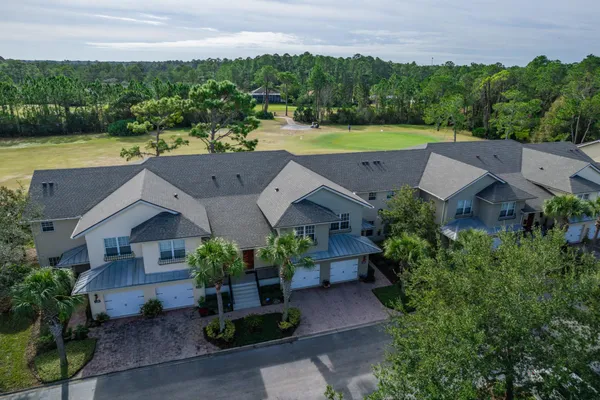 an aerial view of a house with garden space and lake view