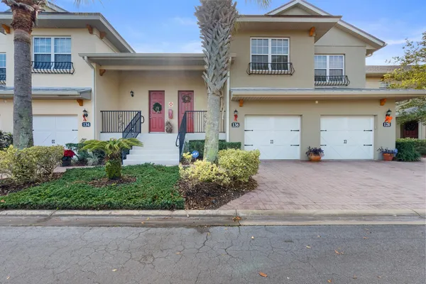 a front view of a house with a yard and a garage