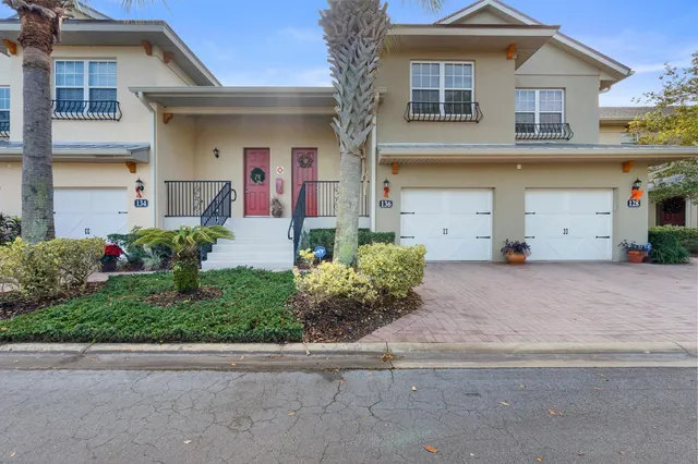 a front view of a house with a yard and a garage