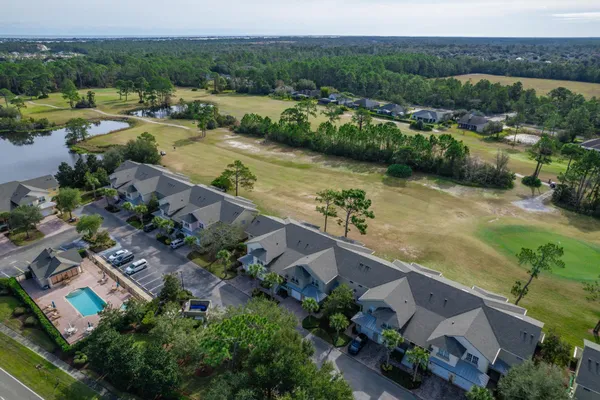 an aerial view of residential houses with outdoor space and river