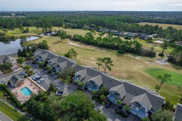 an aerial view of residential houses with outdoor space and river