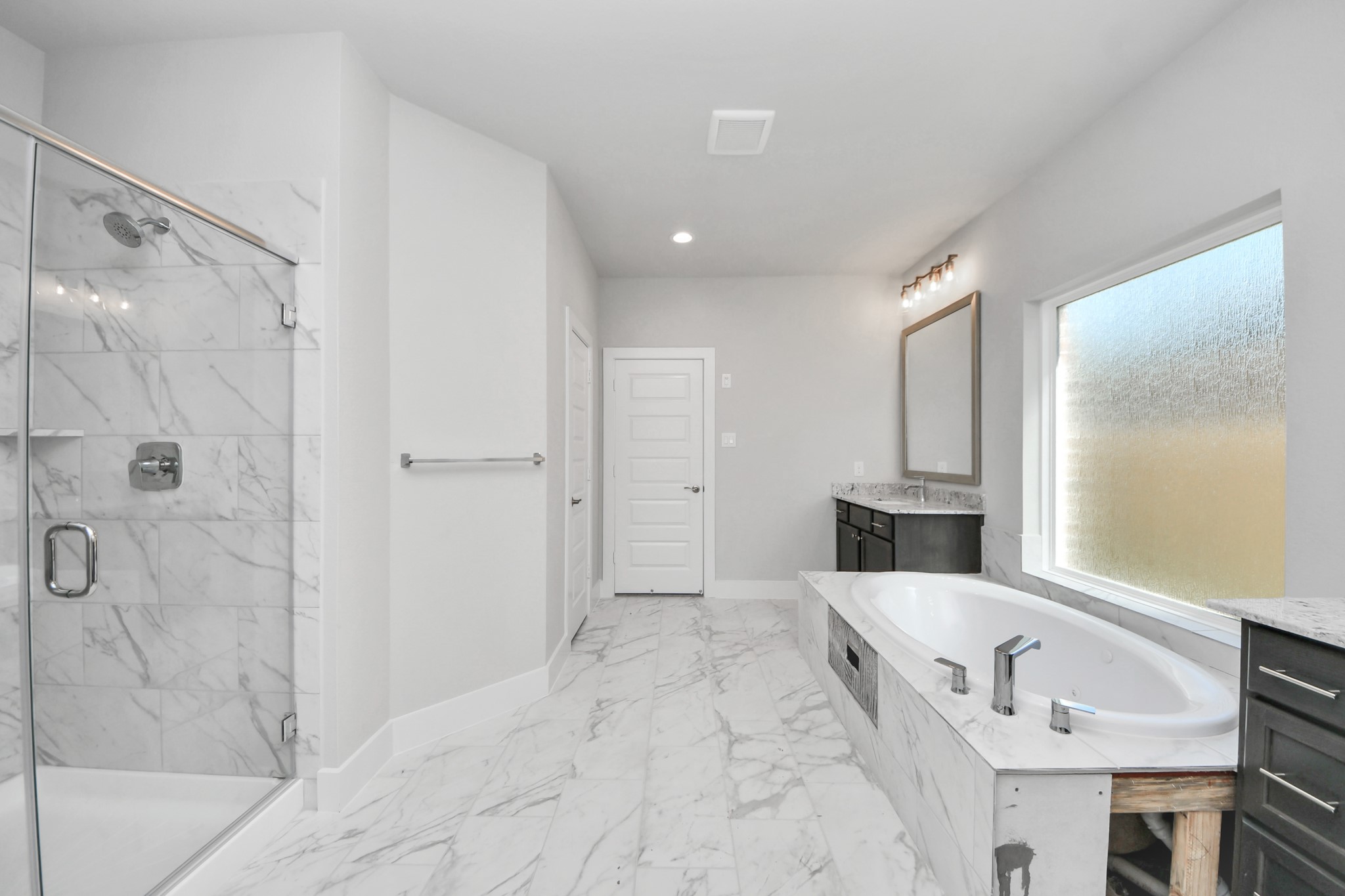 3110 Native Spg Drive Spring, TX 77373 - Photo 21 of 34 Indulge in a spa-like retreat within the confines of this primary bathroom. Delight in a spacious walk-in shower enveloped in stylish tile surround, unwind in a separate garden tub adorned with custom detailing. Sample photo of completed home with similar floor plan. Actual colors and selections may vary.