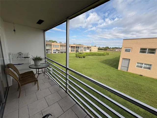 a view of a two chairs in the balcony