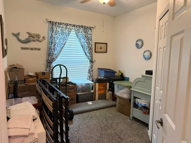 a room with glass door and chandelier
