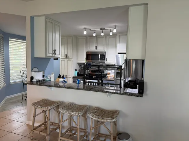 a view of a dining room with furniture and a window