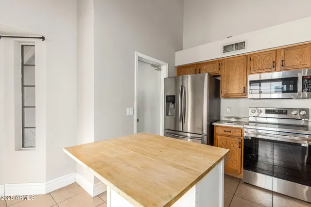 a kitchen with stainless steel appliances kitchen island a cabinets and wooden floor