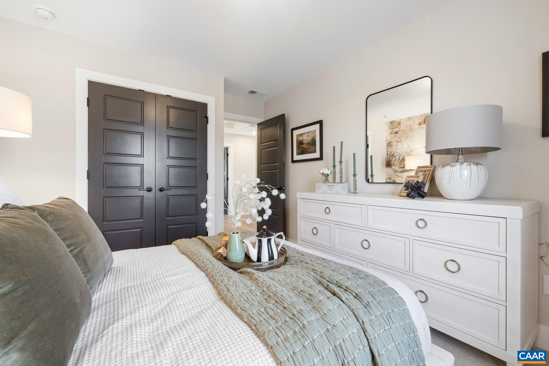 48 B Miranda Crossing Charlottesville, VA 22901 - Photo 18 of 28 a bedroom with a bed and a lamp
