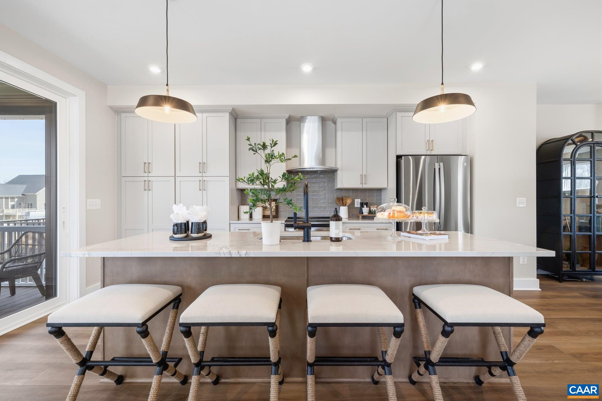 48 B Miranda Crossing Charlottesville, VA 22901 - Photo 8 of 28 a kitchen with a dining table chairs and a chandelier