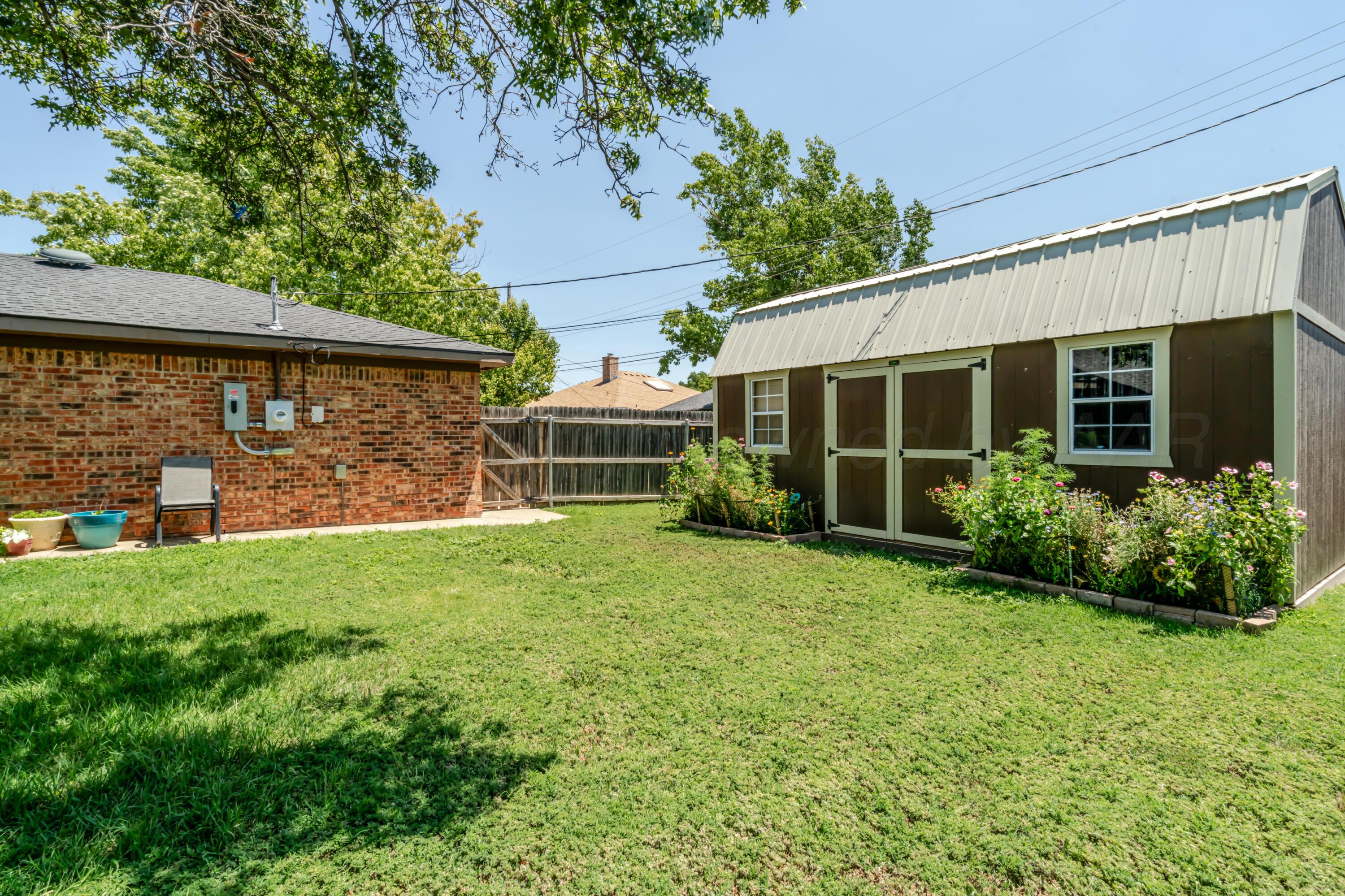 7909 Gerald Drive Amarillo, TX 79121 - Photo 19 of 26 a front view of a house with garden