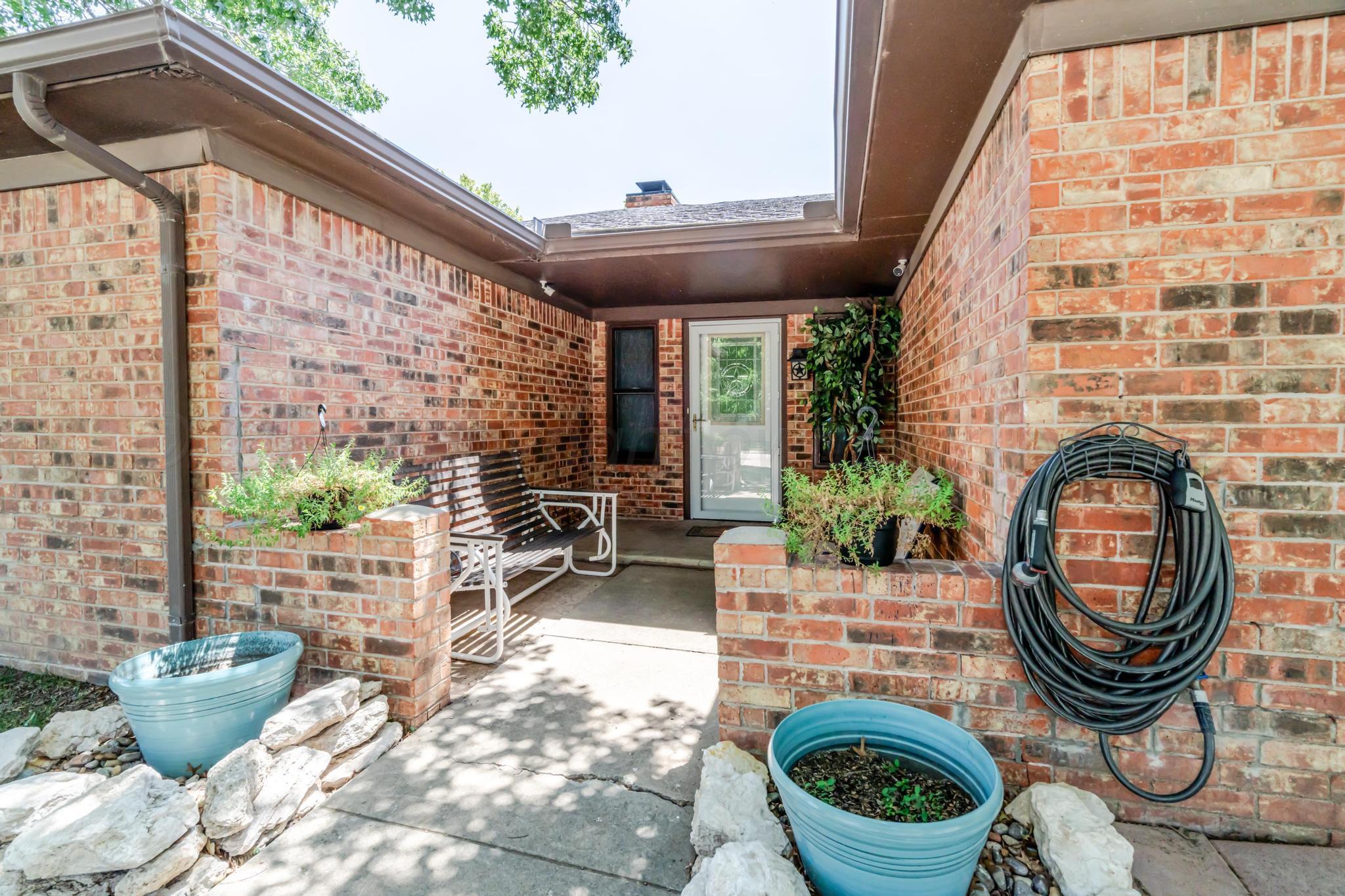 7909 Gerald Drive Amarillo, TX 79121 - Photo 2 of 26 a living room with furniture a window and a fireplace