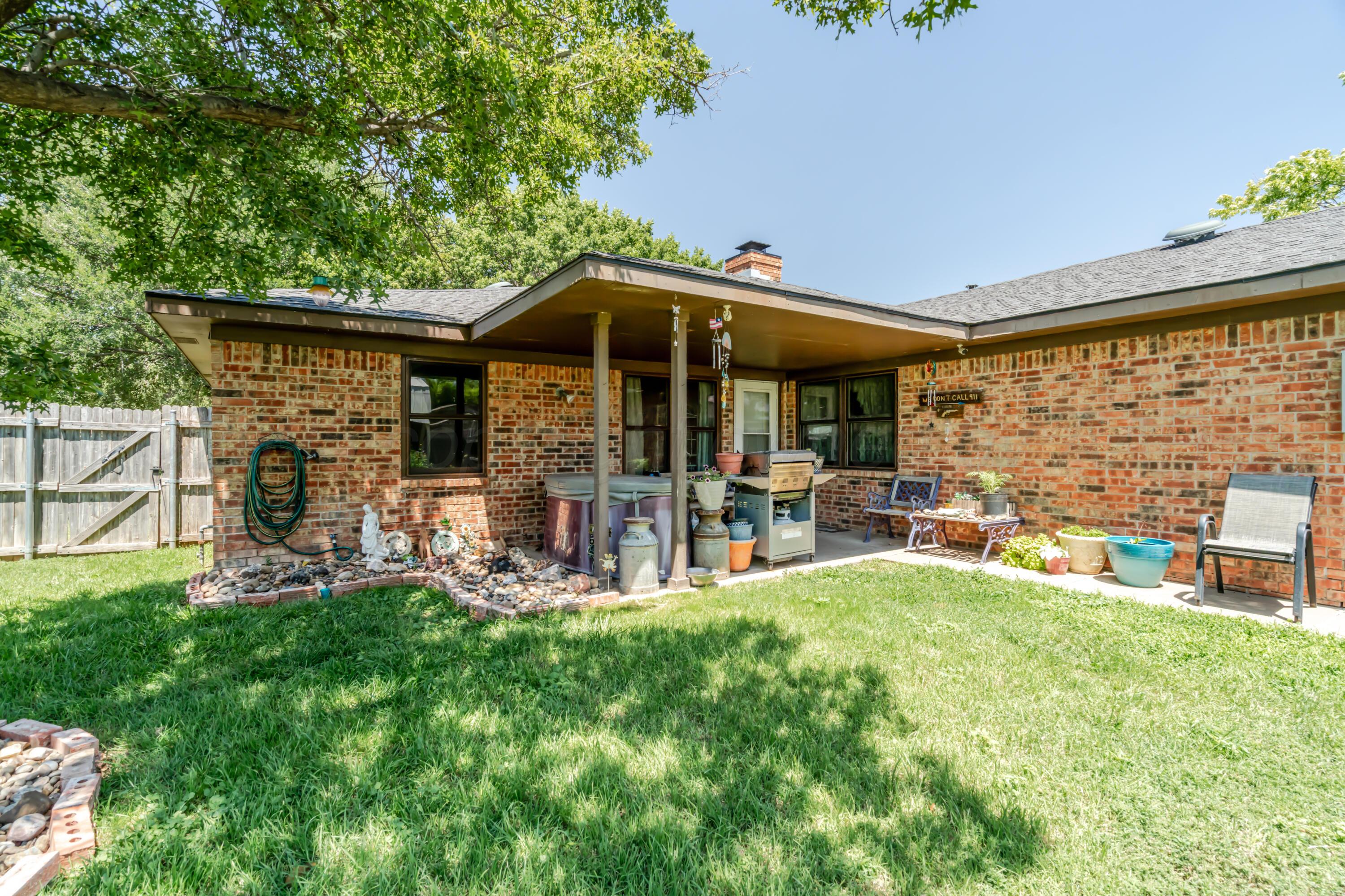7909 Gerald Drive Amarillo, TX 79121 - Photo 22 of 26 a view of a chair and table in backyard of the house