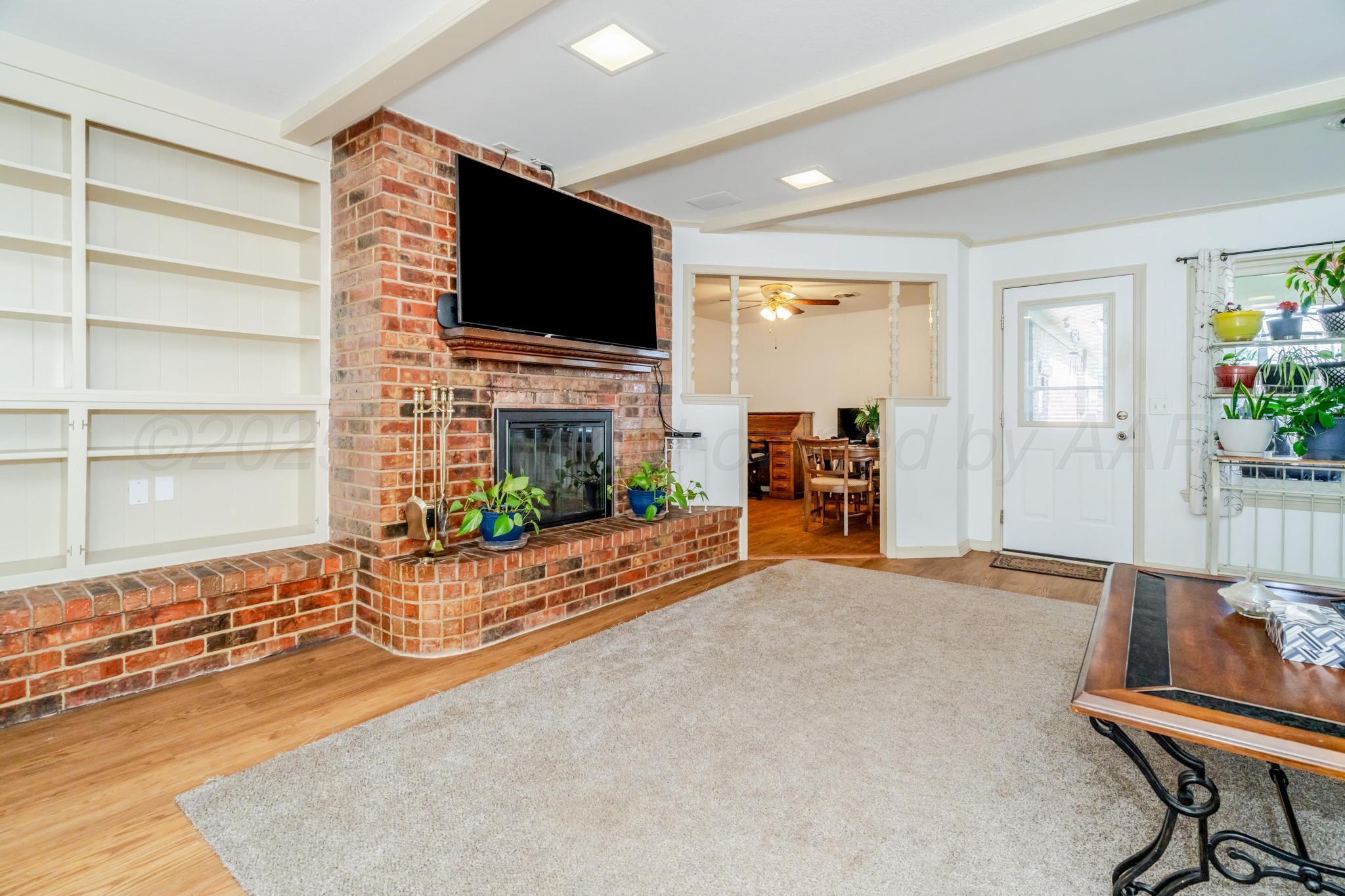 7909 Gerald Drive Amarillo, TX 79121 - Photo 4 of 26 a view of a livingroom with furniture and a flat screen tv