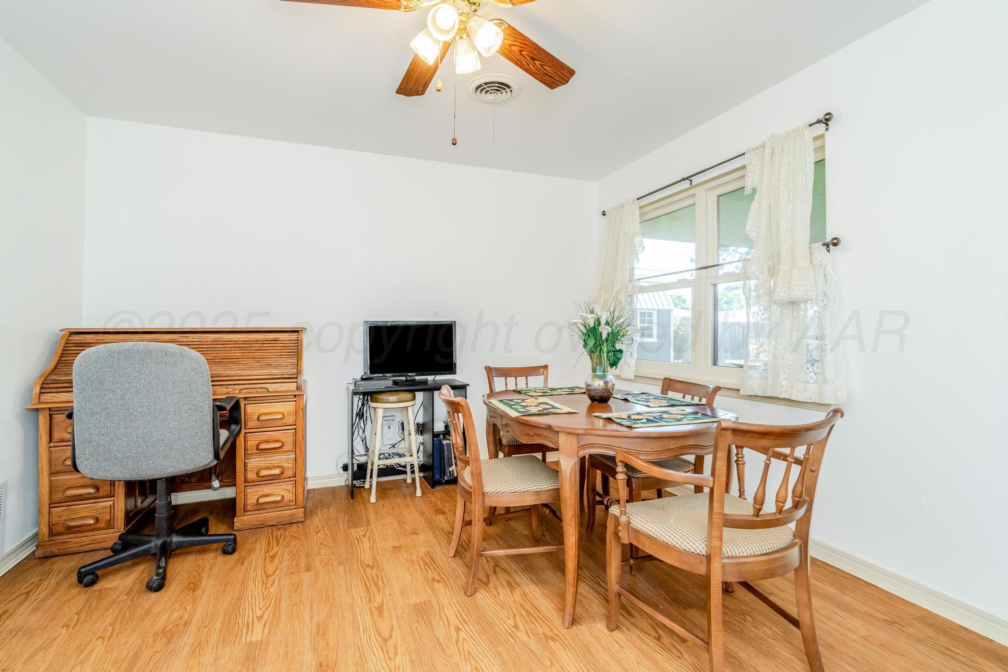 7909 Gerald Drive Amarillo, TX 79121 - Photo 7 of 26 a view of a dining room with furniture window and wooden floor