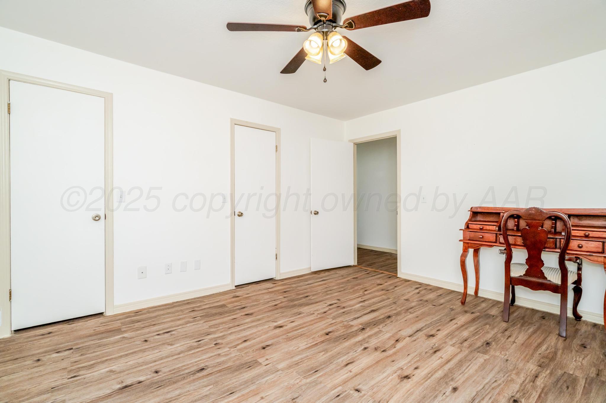 7909 Gerald Drive Amarillo, TX 79121 - Photo 8 of 26 a view of empty room with wooden floor