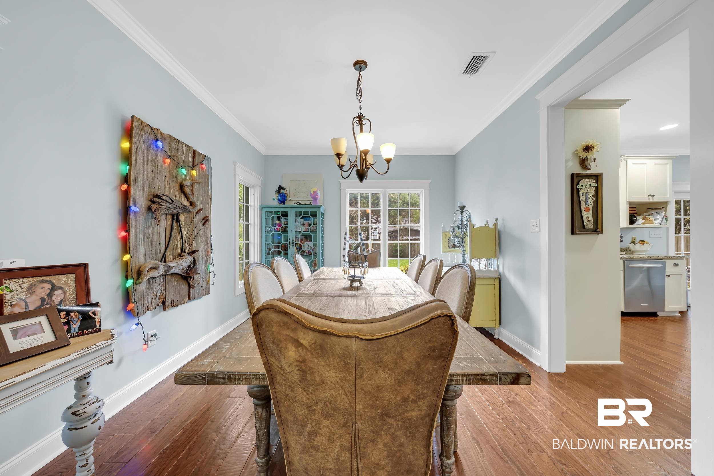 7 Bienville Avenue Mobile, AL 36606 - Photo 11 of 32 Dining space featuring crown molding, wood finished floors, and a chandelier