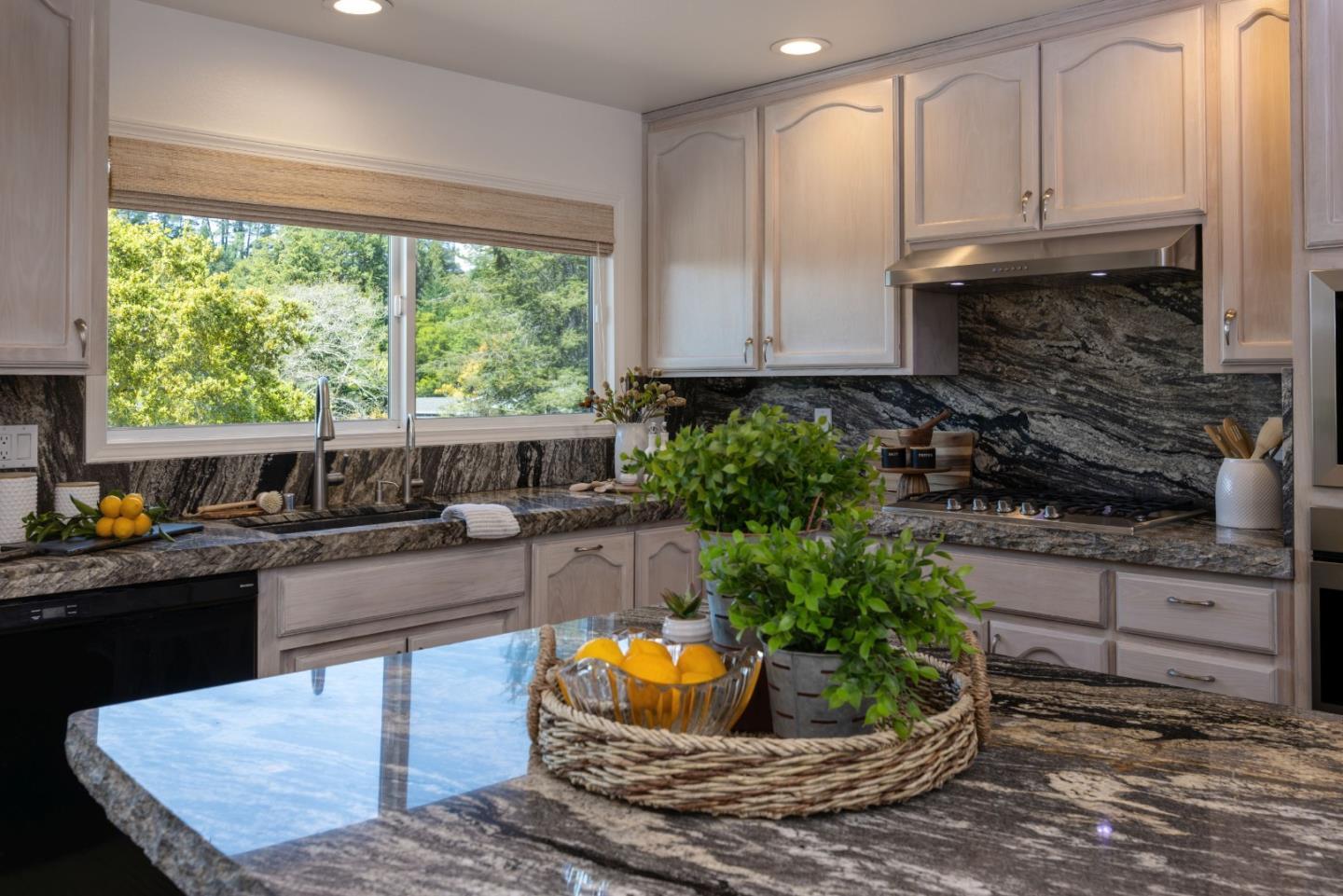 573 Meadow Road Aptos, CA 95003 - Photo 14 of 53 a kitchen with granite countertop a stove a sink and a granite counter top