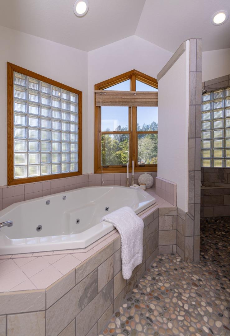 573 Meadow Road Aptos, CA 95003 - Photo 33 of 53 a spacious bedroom with a bed and a large window