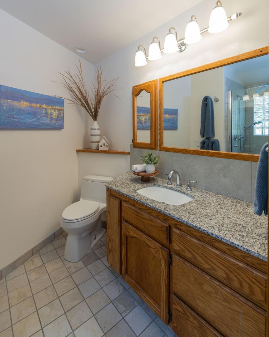 573 Meadow Road Aptos, CA 95003 - Photo 42 of 53 a bathroom with a granite countertop sink mirror vanity and toilet