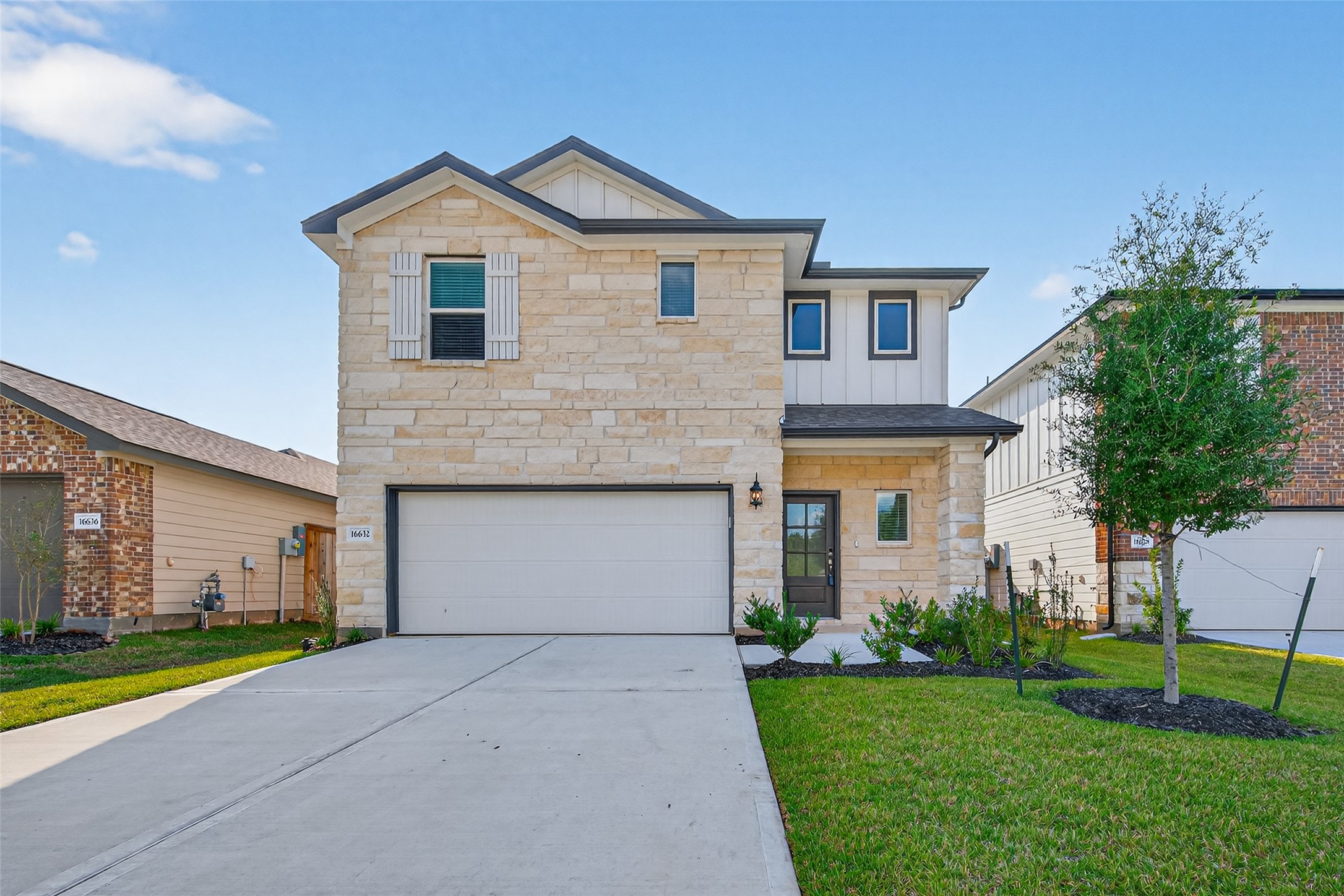 a front view of a house with a yard and garage