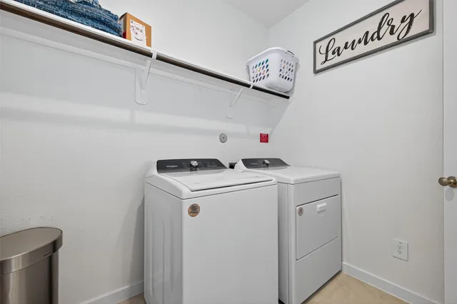 a living room with furniture and a view of kitchen