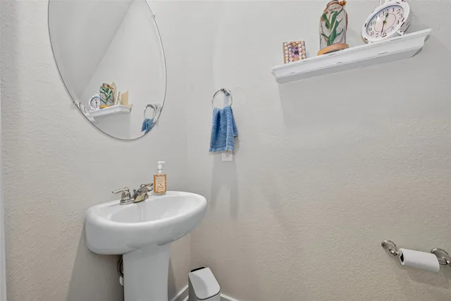 a bathroom with a sink and mirror