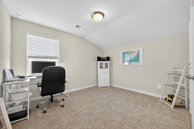 a view of a patio with table and chairs potted plants and large tree