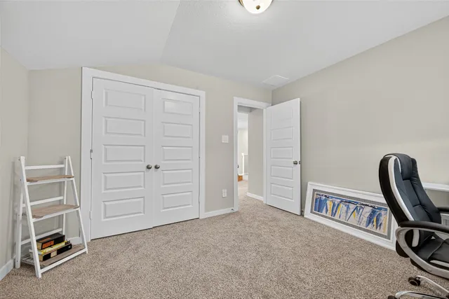 a living room filled with furniture and a potted plant