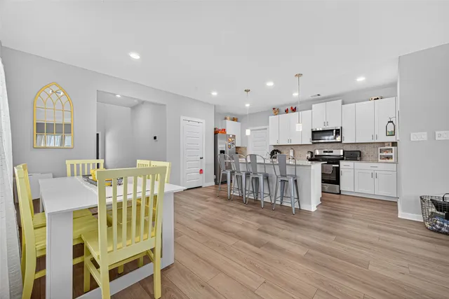 a kitchen with stainless steel appliances granite countertop white cabinets a sink and dishwasher